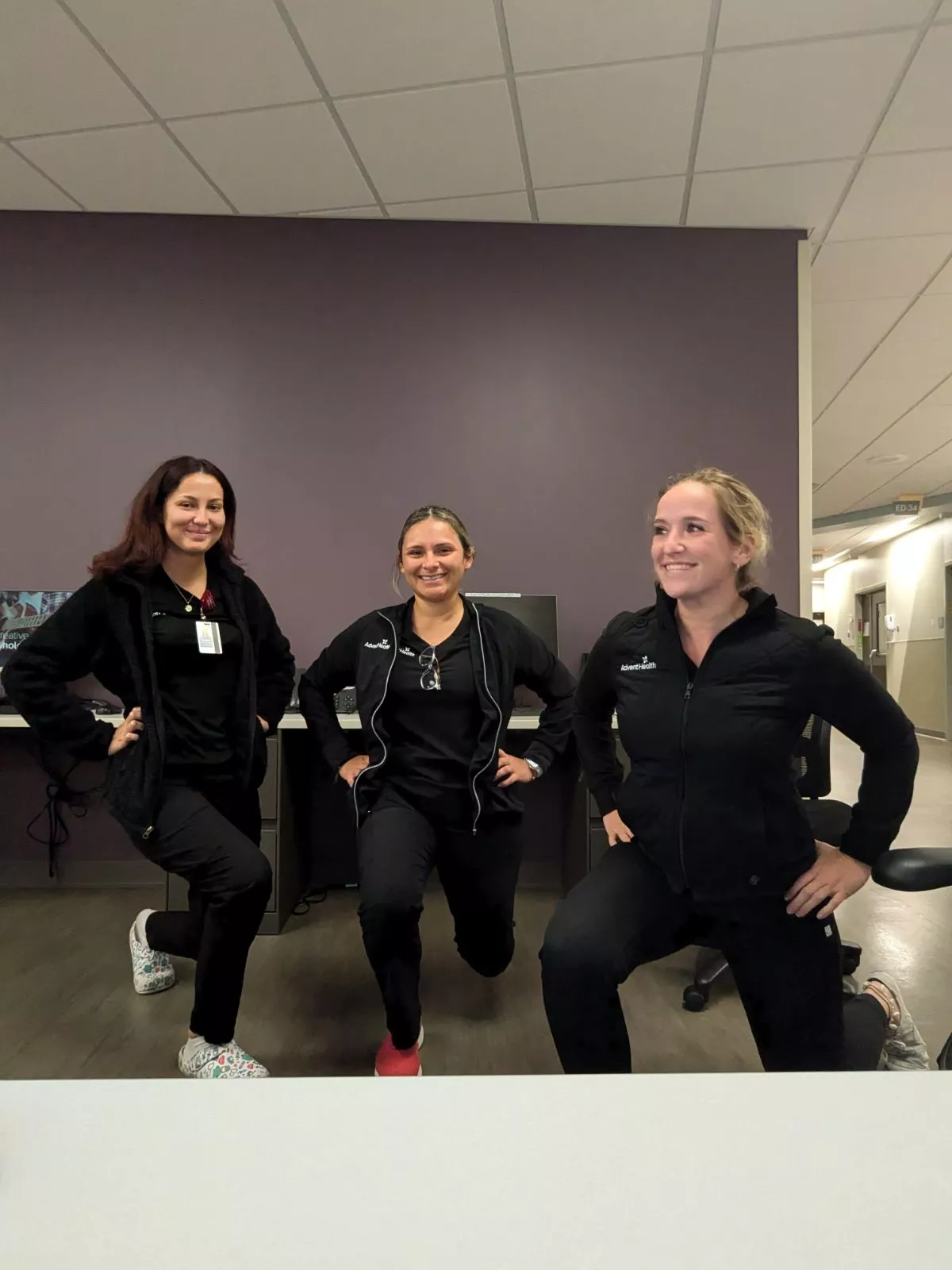 Eseman leading her team to perform standing lunges during a work break.