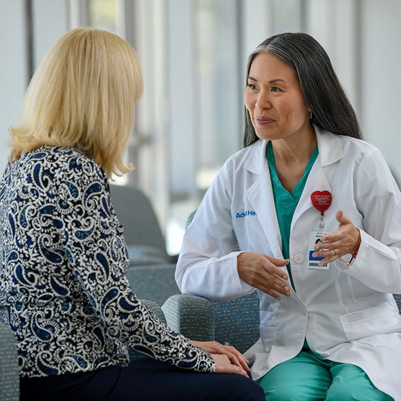 A seated doctor and patient having a conversation